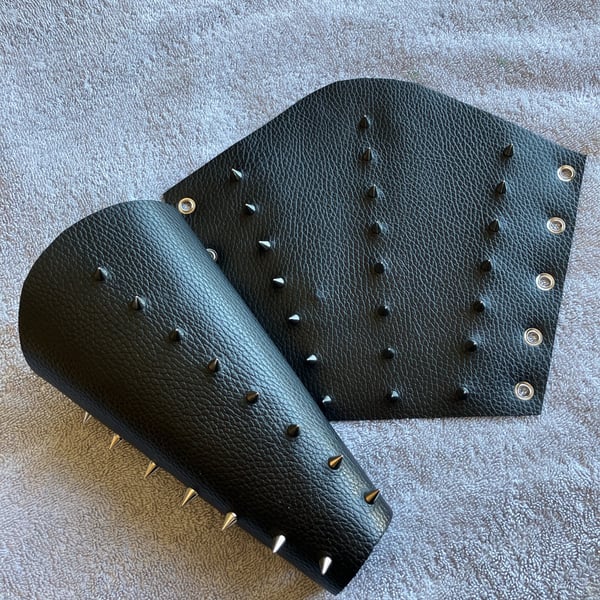 Large pair of black leather bracers with 3 rows of Chrome coloured spikes
