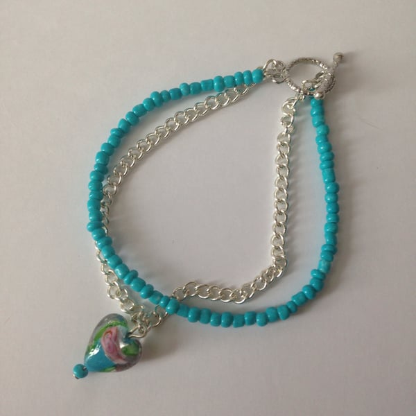 Blue beads and silver plated chain bracket with blue heart charm