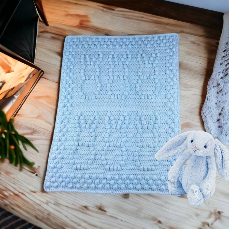 Crochet baby blanket in light blue with puff bobbly bunny pattern