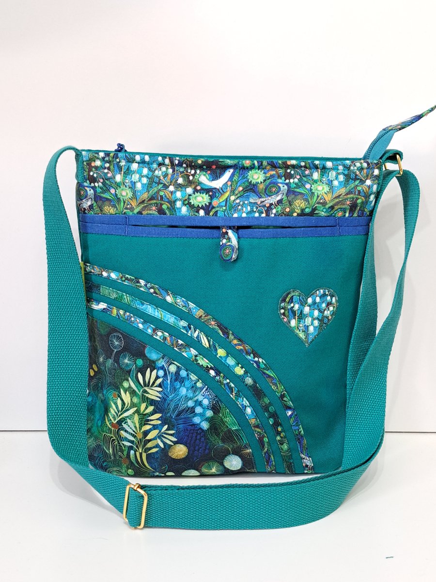Green handbag with lily of  the valley and birds