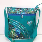 Green handbag with lily of  the valley and birds