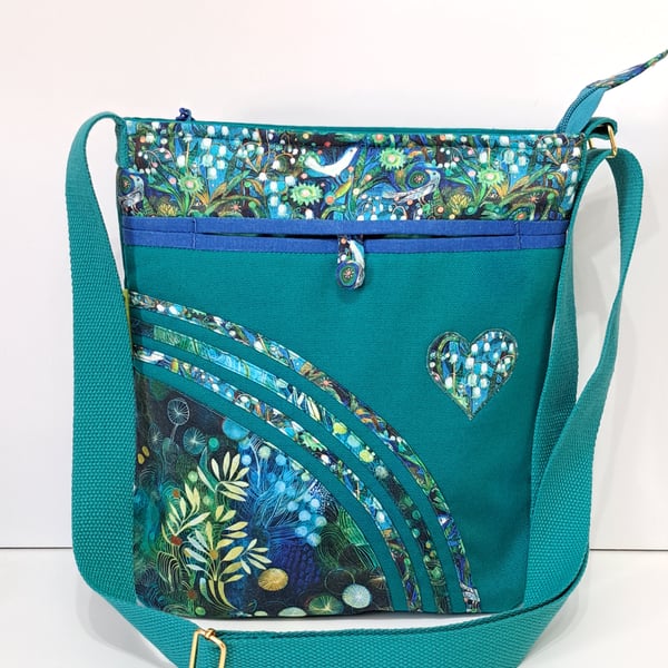 Green handbag with lily of  the valley and birds