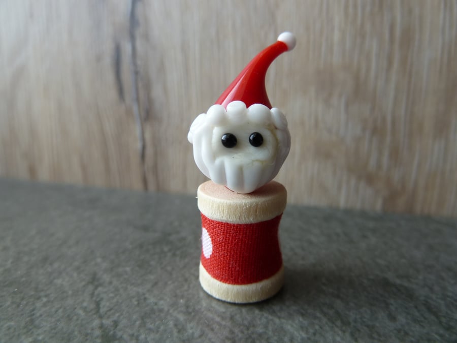wooden spool with father christmas