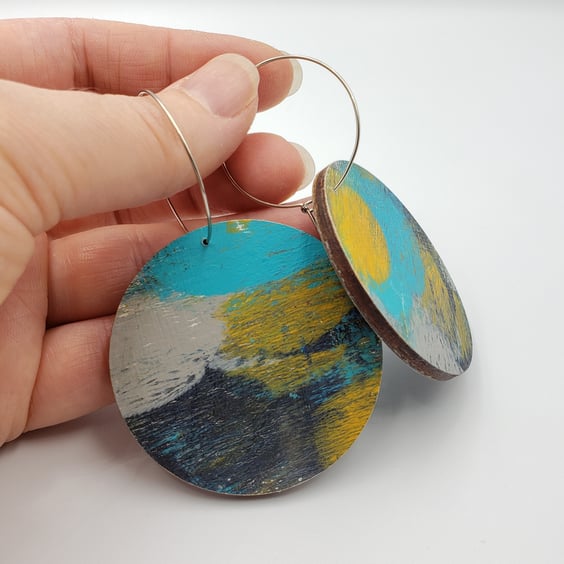 Large earrings in blue, mustard yellow, dark grey, light grey and white