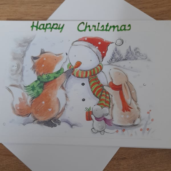 CUTE CHRISTMAS CARD WITH FOX, RABBIT AND MOUSE MAKING A SNOW MAN.