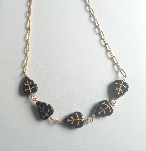 Gold filled chain necklace with black and gold Czech glass  leaf beads