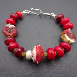 red lampwork glass bracelet, polymer clay toadstool