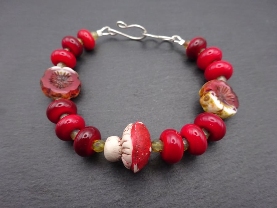 red lampwork glass bracelet, polymer clay toadstool