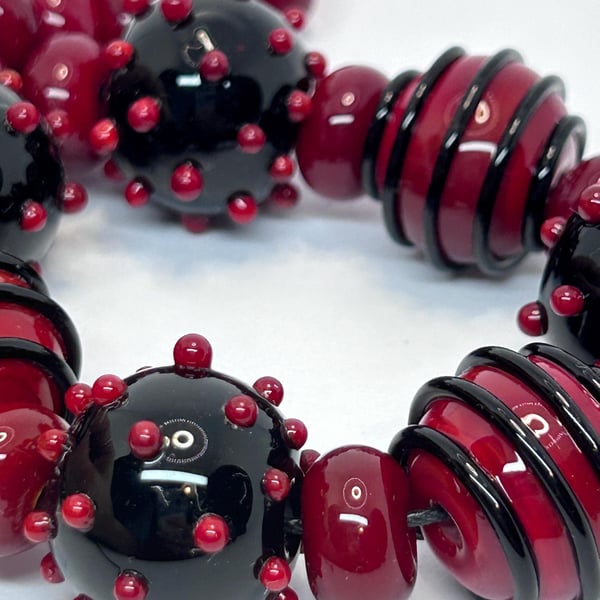 Handmade red and black lamp work glass beads