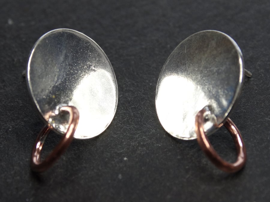 Sterling silver tarow studs. Silver disc with copper detailing.