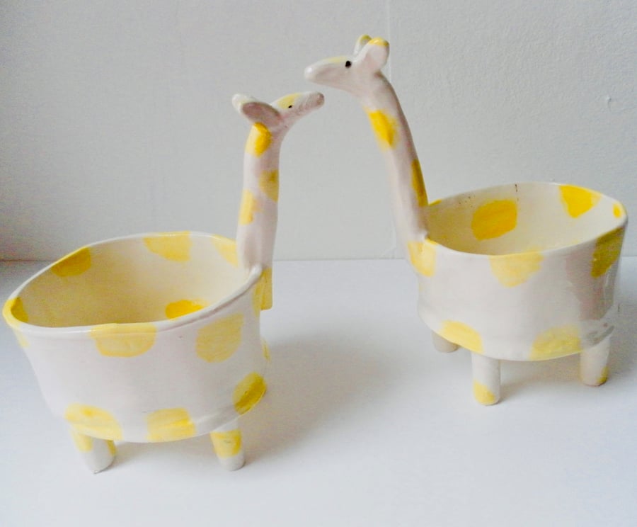 A PAIR OF GIRAFFE PLANTERS HIM AND HER