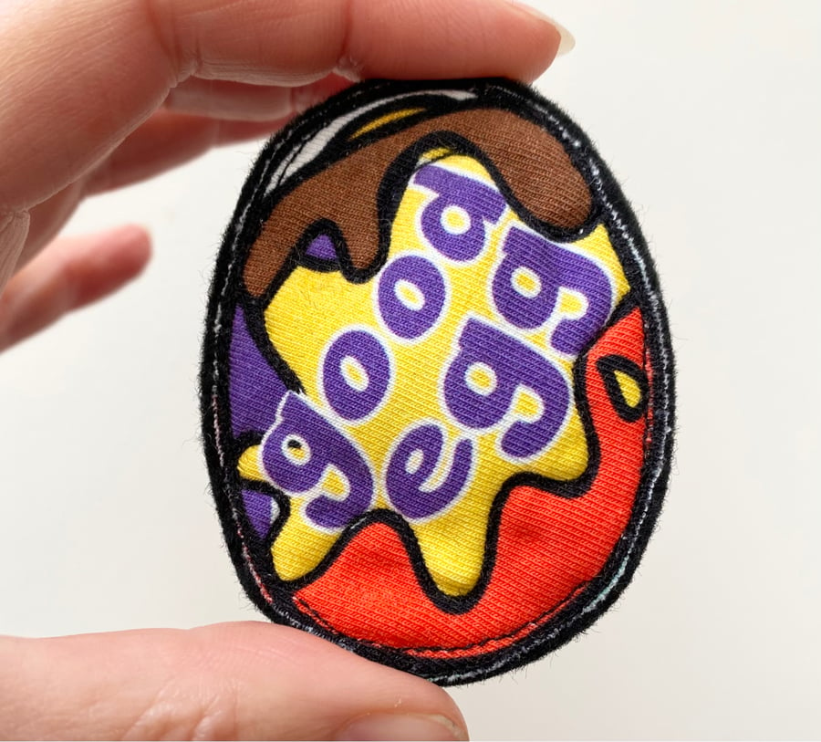 Up-cycled chocolate egg brooch pin or badge. 