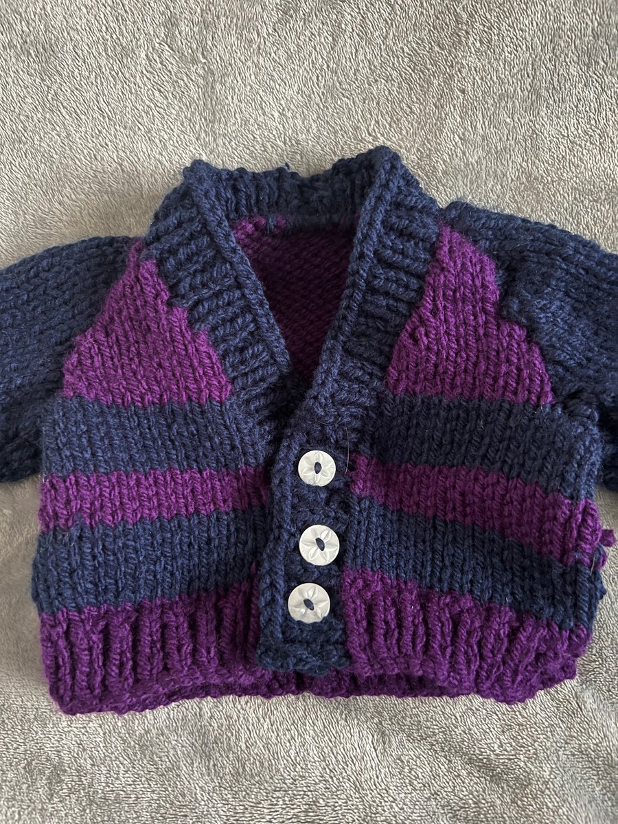 Hand knitted baby cardigan in stripey blue and purple 