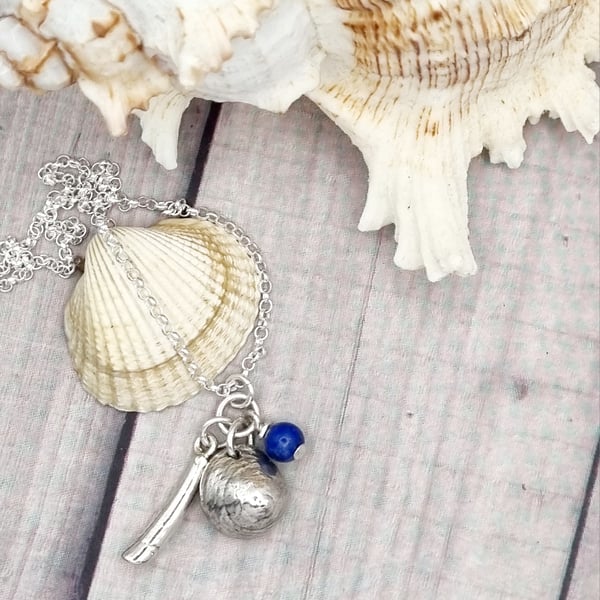Real shells coated in silver with lapis lazuli bead, unique item!