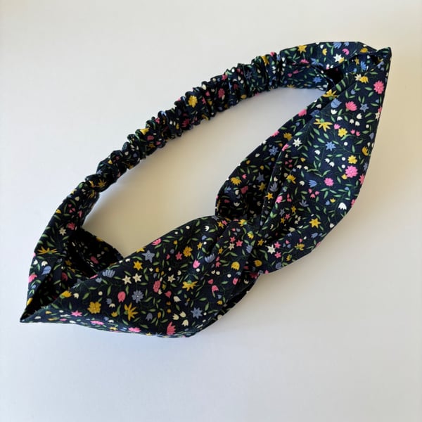 Cotton headband, twist knot style hairband in navy with bright flowers.