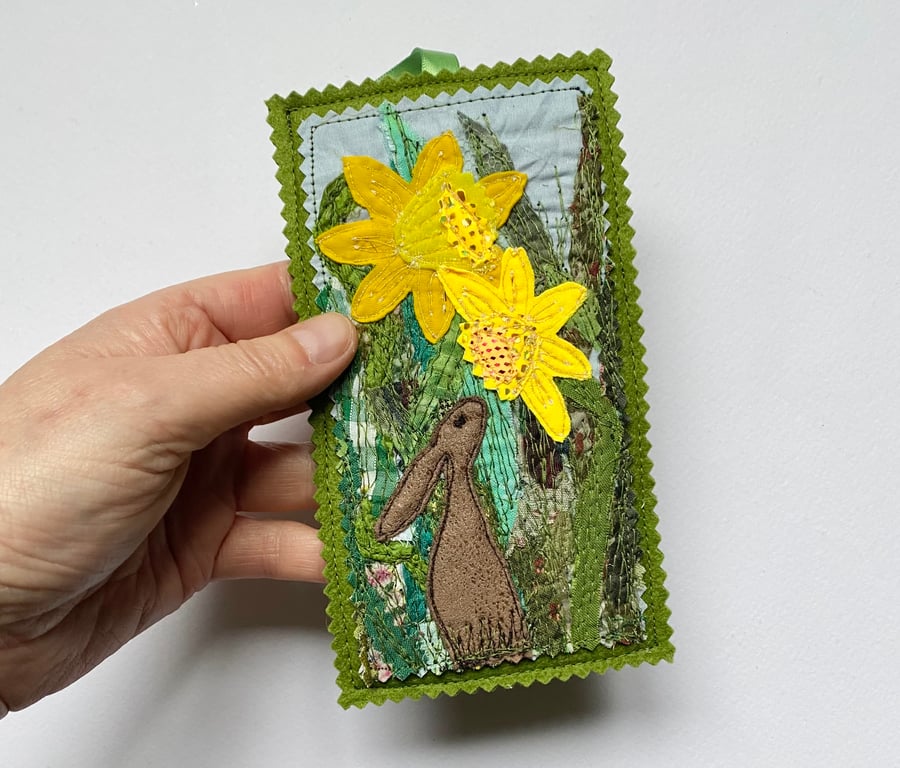 Upcycled embroidered spring rabbit and daffodil home decoration.