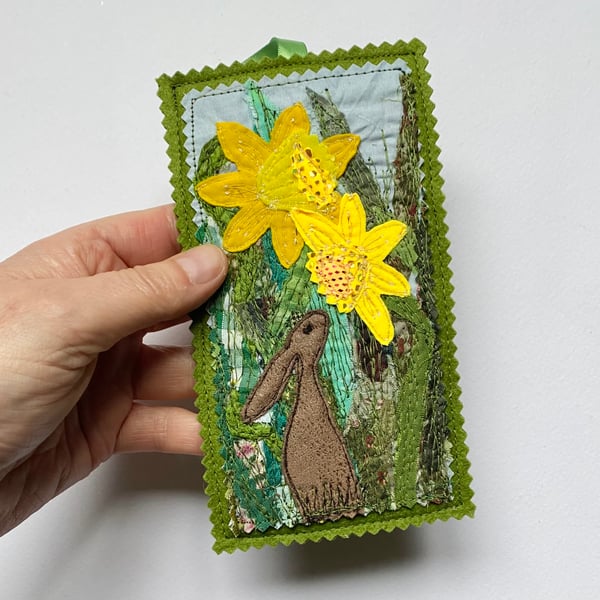 Upcycled embroidered spring rabbit and daffodil home decoration.