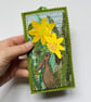 Upcycled embroidered spring rabbit and daffodil home decoration.