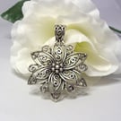 Large silver tone flower pendant