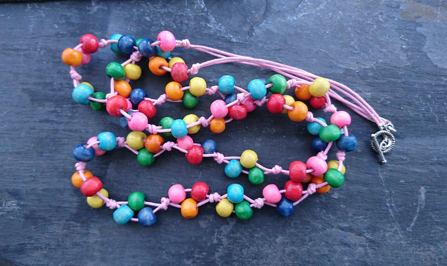 Rainbow wooden necklace on pale pink cotton cord