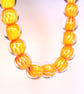 Handmade orange and white patterned lamp work glass beads