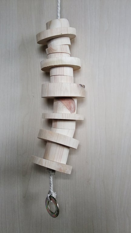 Toy for a caged bird, made from different sized round pieces of smooth pine.
