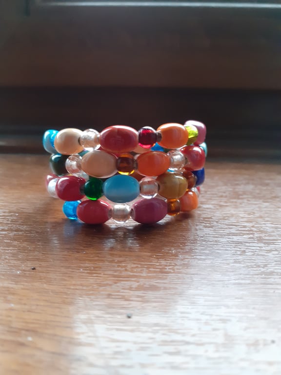 MULTI COLOURED HANDMADE CERAMIC MEMORY WIRE BRACELET.