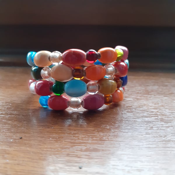 MULTI COLOURED HANDMADE CERAMIC MEMORY WIRE BRACELET.