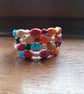 MULTI COLOURED HANDMADE CERAMIC MEMORY WIRE BRACELET. - Image 1