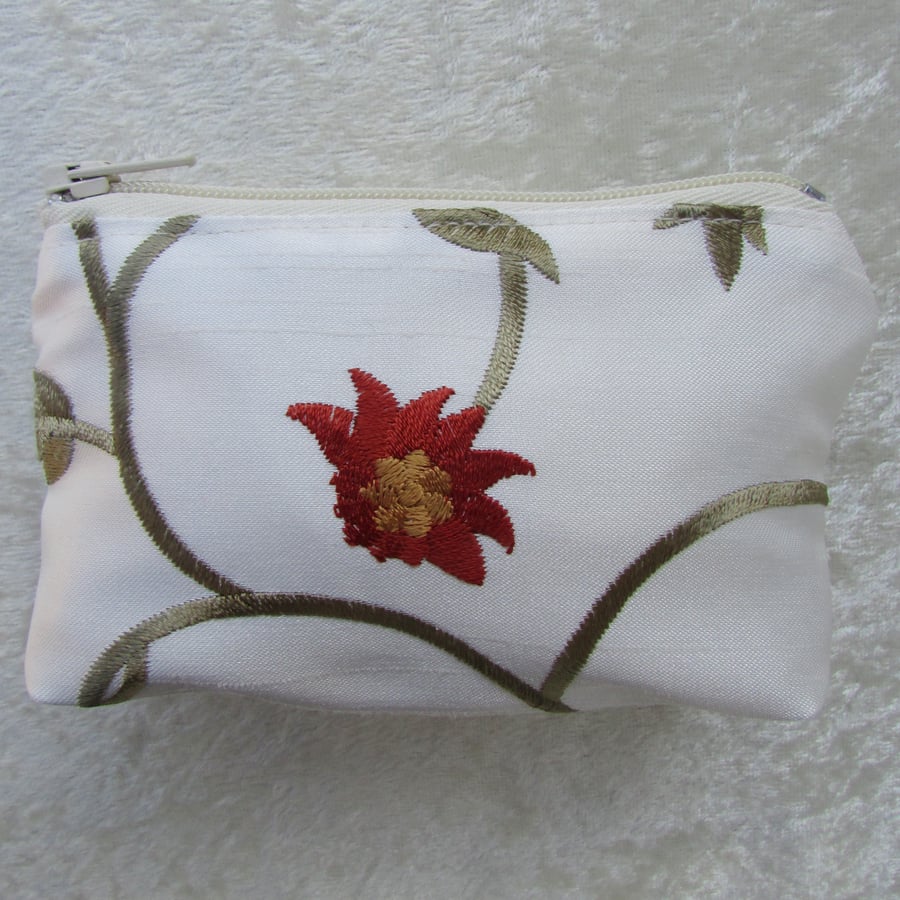 Small purse in ivory with orange, yellow and green floral pattern