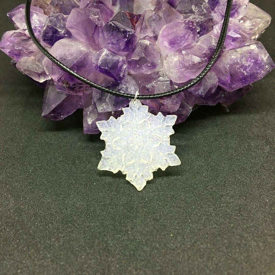 Snowflake with glitter pendant and black cord chain.