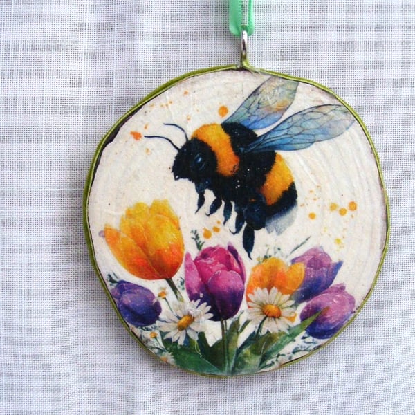 Bee and tulip decoupaged log slice wall decoration.