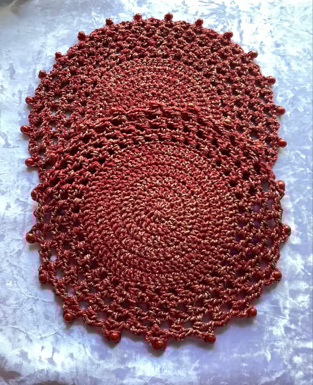 Red and gold round doilies , beaded coasters