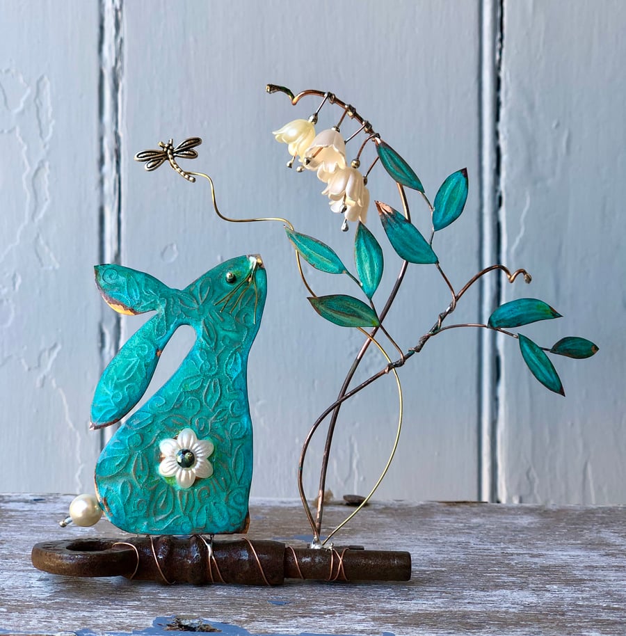 Hare smelling the Lily of the Valley