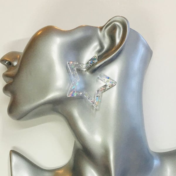 Opaque sparkly star hoop statement earrings.