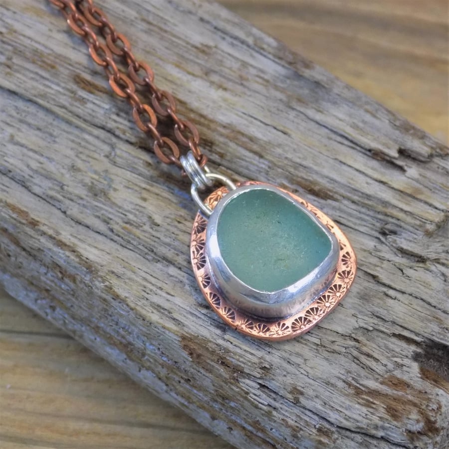 Copper and silver bezel set sea glass pendant 