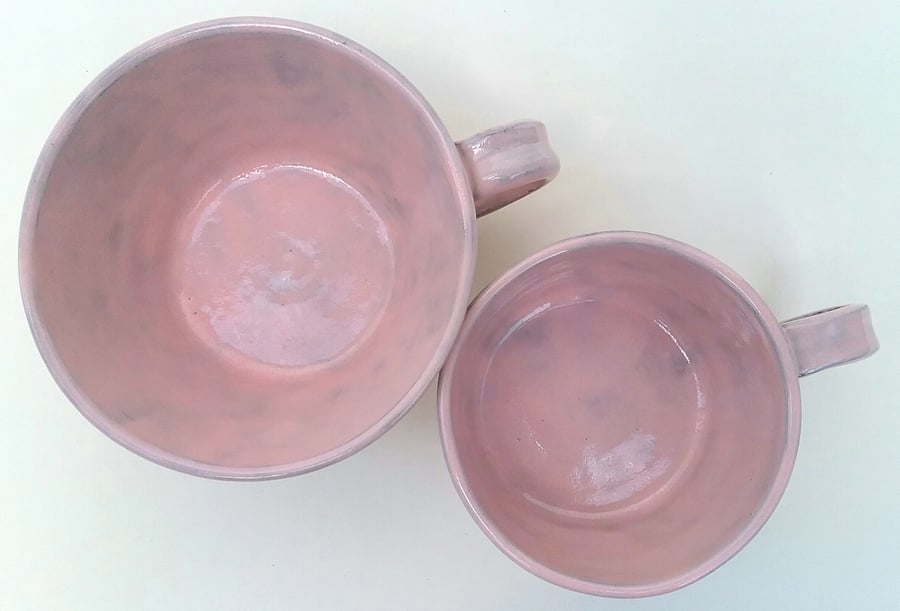 Pink ceramic handmade tea or coffee cup in terracotta clay with shiny glaze