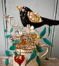 Blackbird sitting in his nest on a small vintage cup - Image 2