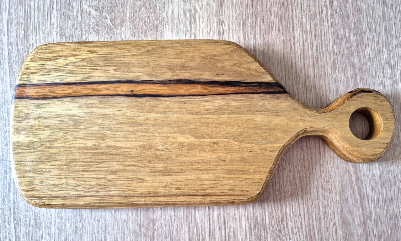 Beautiful unique chopping board made from black limba wood. 