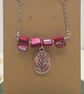 Pink mother of pearl beaded necklace with silver floral charm - Image 2