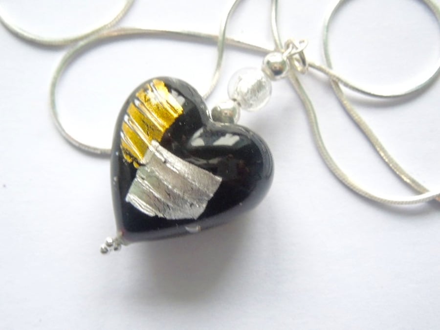 Black,silver and gold Murano glass heart pendant with sterling silver chain.