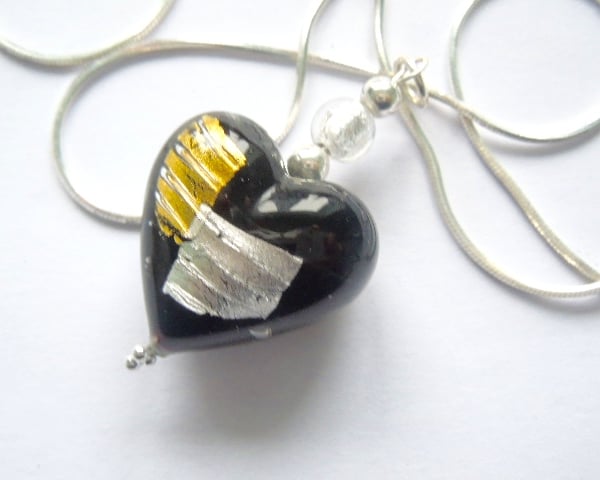 Black,silver and gold Murano glass heart pendant with sterling silver chain.