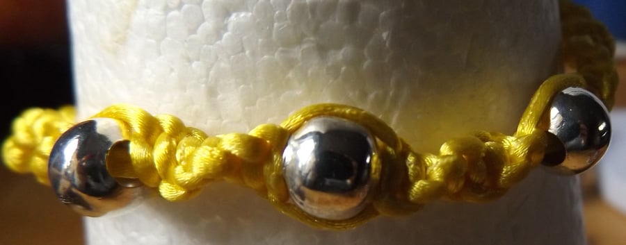 Yellow macrame bracelet with silver heart charm