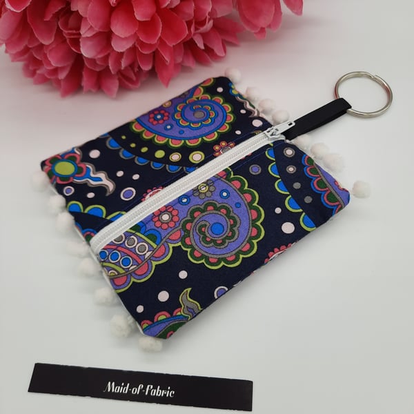 Coin purse keyring in navy patterned fabric. 