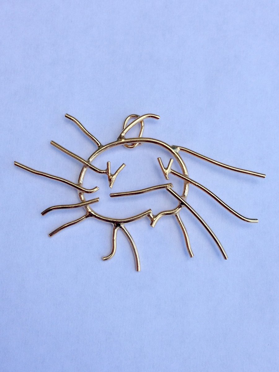A personalised sterling silver sun pendant from a childs drawing. 24ct gold plat