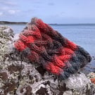 Hand knitted lined headband featuring Celtic knot pattern.