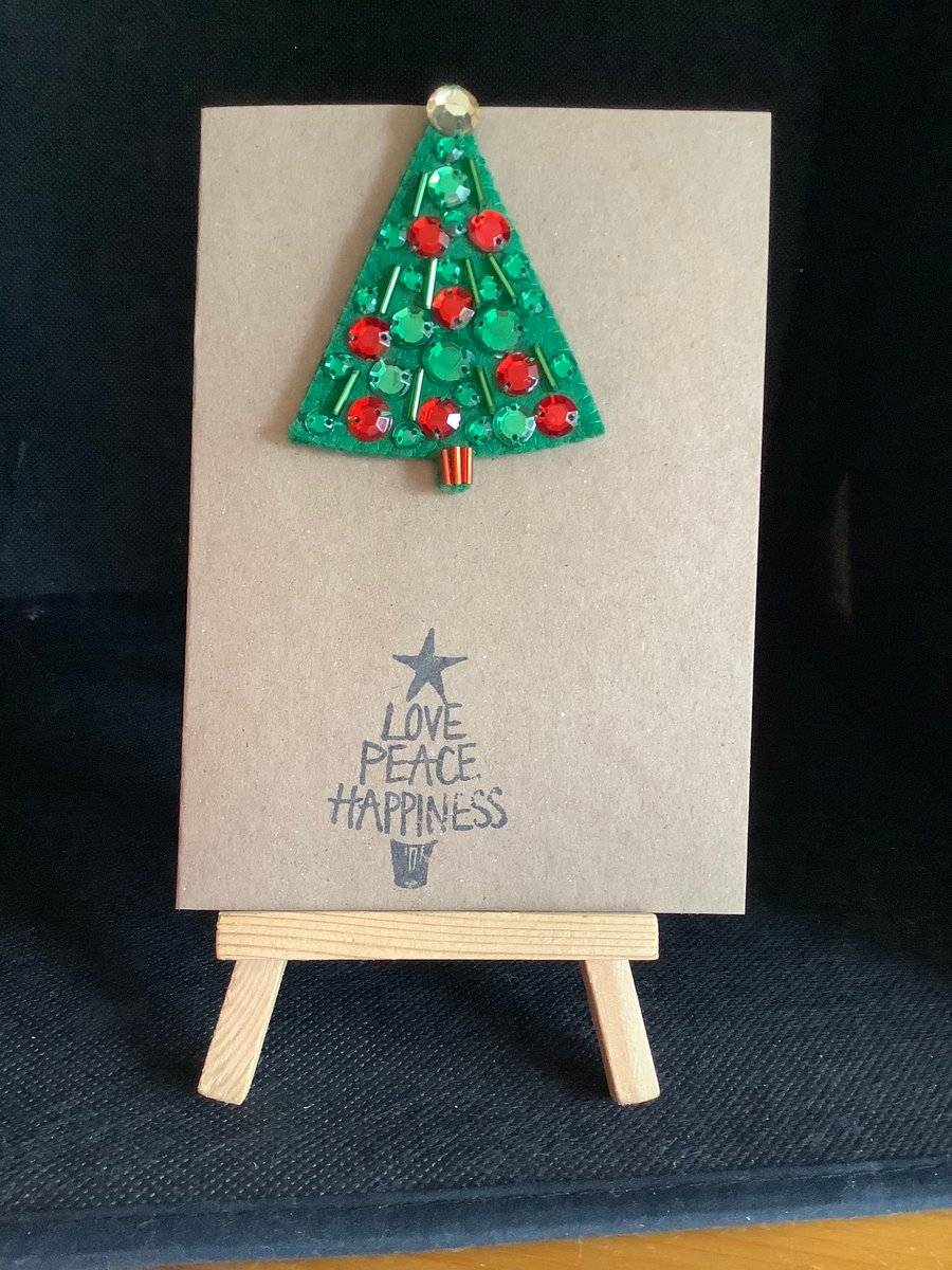 A handmade, felt,  Christmas Tree brooch, attached to a hand stamped kraft card