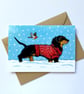 Dachshund wearing Xmas Jumper Snowy Seasonal Greeting Card - Image 1