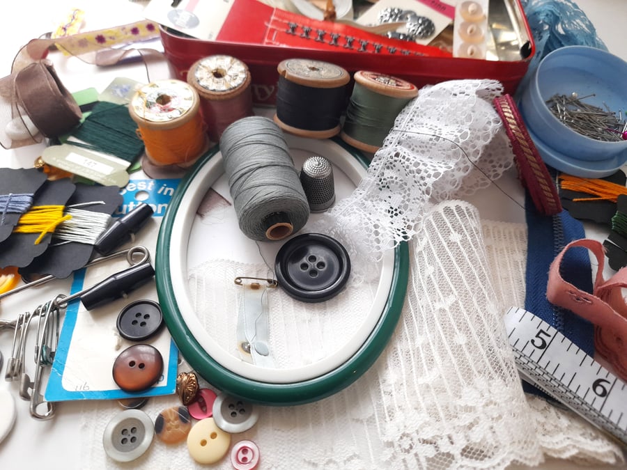 Vintage sewing haberdashery kit in an old metal biscuit tin