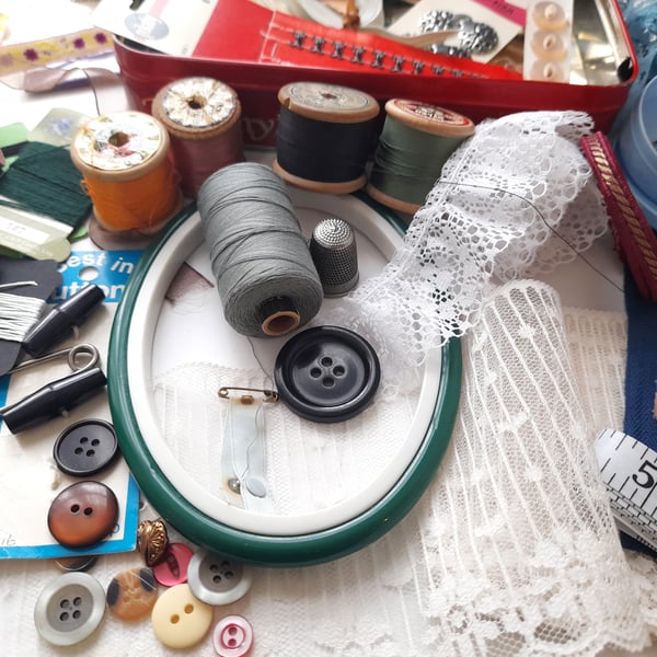 Vintage sewing haberdashery kit in an old metal biscuit tin